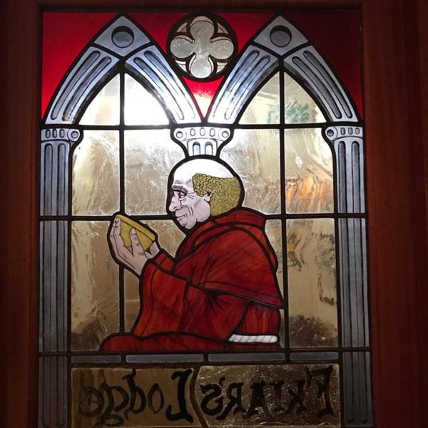金塞尔Friar's Lodge的拿着一本书的人的彩色玻璃窗