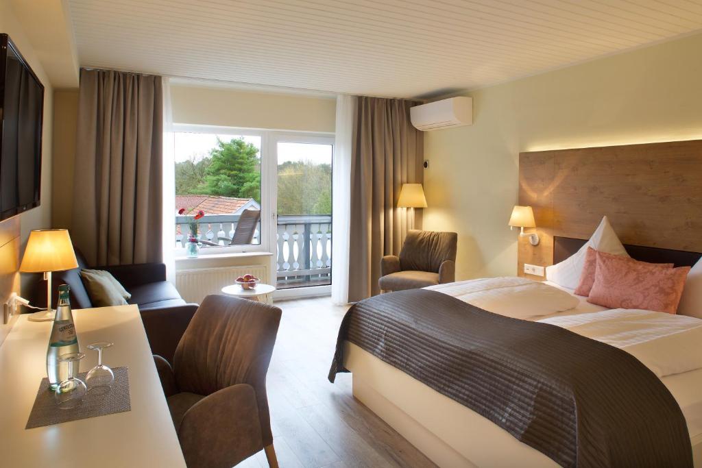 达特尔恩贾梅尔托度假酒店的配有一张床、一张书桌和一扇窗户的酒店客房