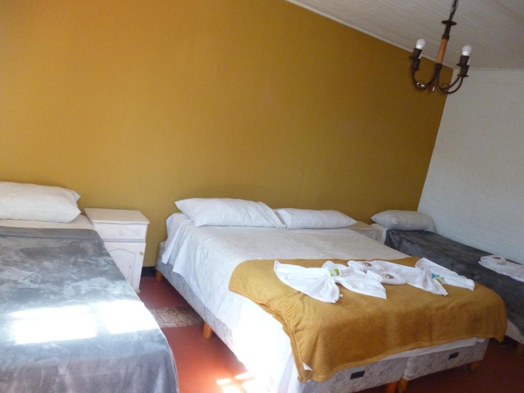 伊瓜苏港巴莎诺瓦套房酒店的一间卧室配有两张带毛巾的床