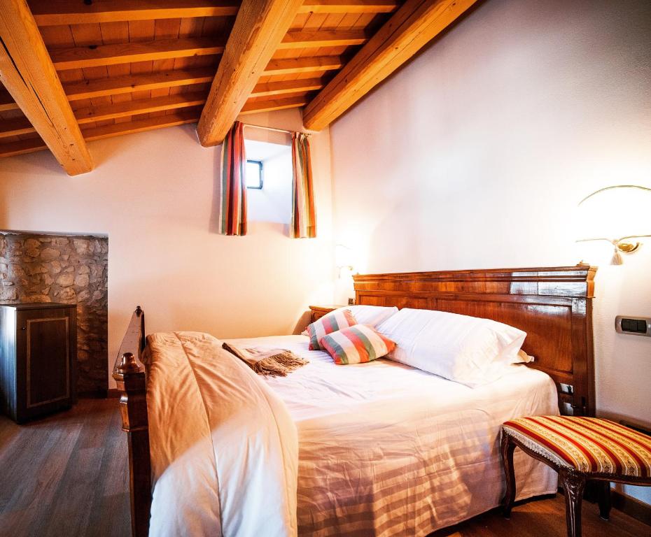 索阿韦Locanda Lo Scudo的一间卧室配有一张带木制床头板的床