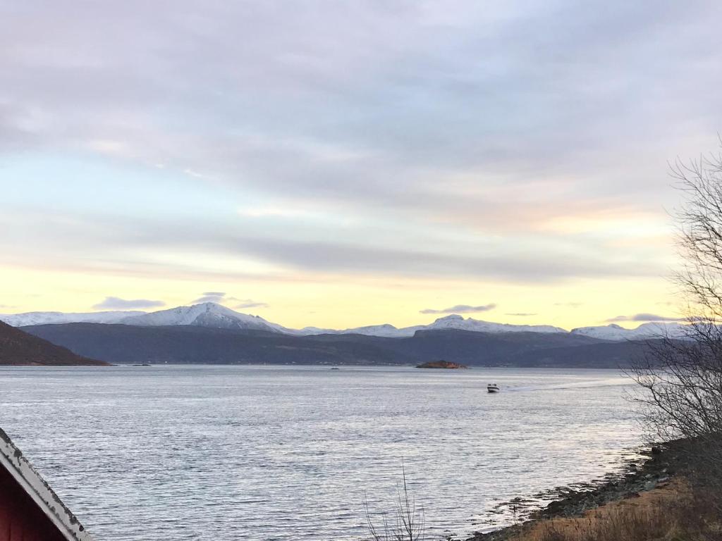 LanesKvaløya Lodge的享有以山脉为背景的湖泊美景