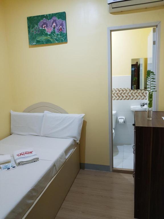 第波罗B&S Orchids suites hotel的客房设有一张床和一间带镜子的浴室