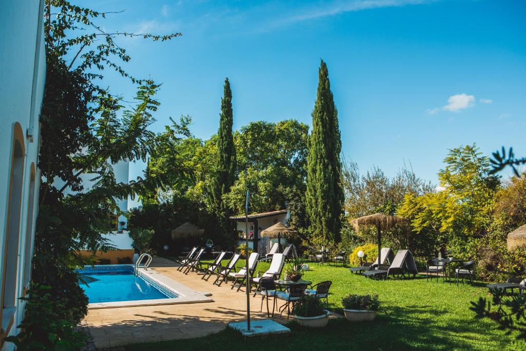 维拉诺瓦德卡塞拉卡萨代卡塞拉韦旅馆的一个带椅子的庭院和一个游泳池
