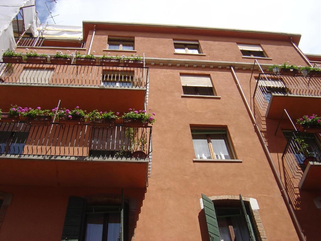 威尼斯艺术家旅馆的一座砖砌建筑,阳台上放着花盒