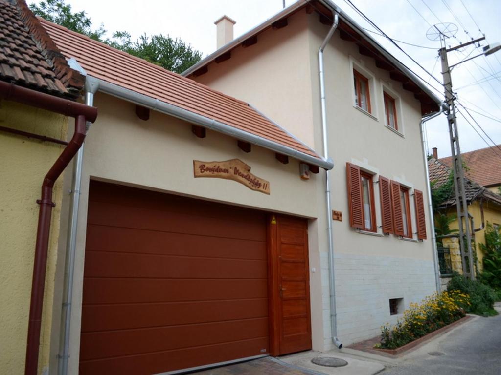 托考伊Borudvar Vendégház II的房屋前的车库,有红色的车库门