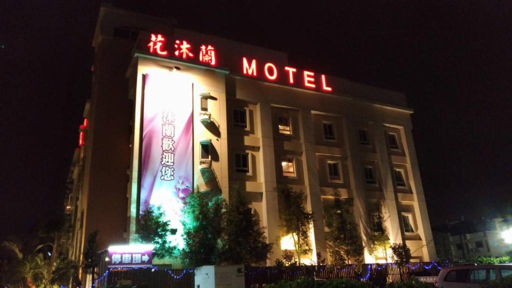 Shalu花沐兰精品旅馆 的一座在晚上有汽车旅馆标志的建筑