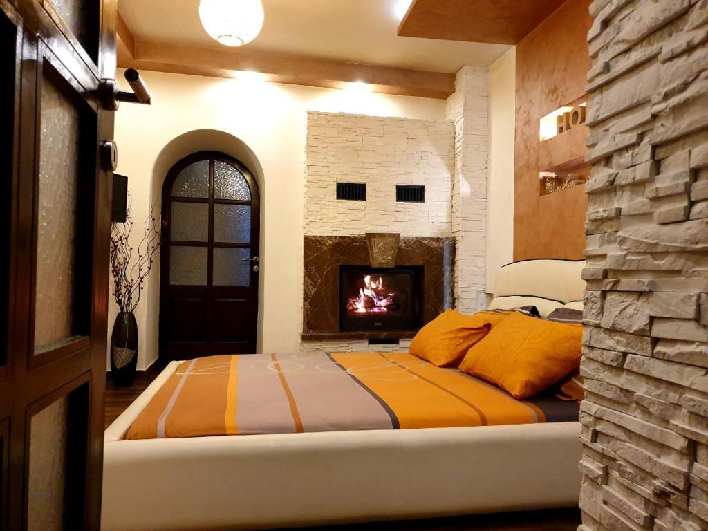 采蒂涅Apartmani vuk的一间卧室配有一张床和一个壁炉