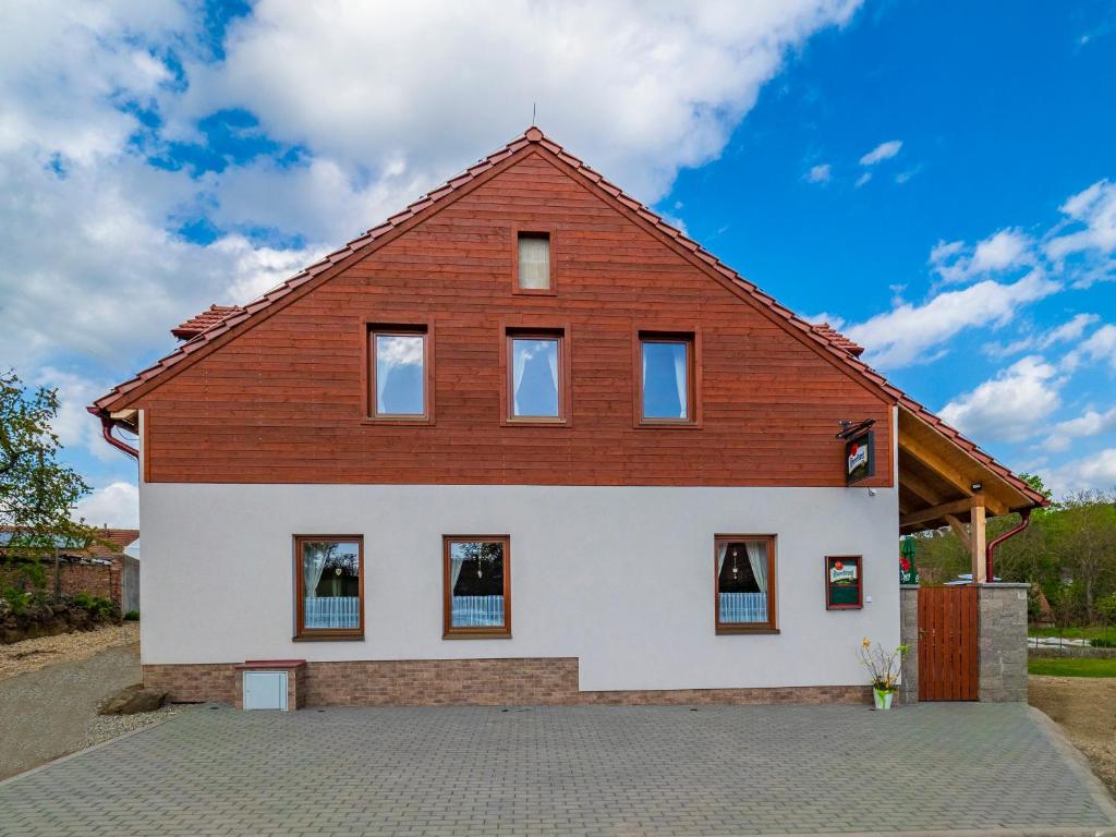 摩拉瓦克鲁姆洛夫Penzion Pastouška s pohostinstvím的白色的大房子,设有木屋顶