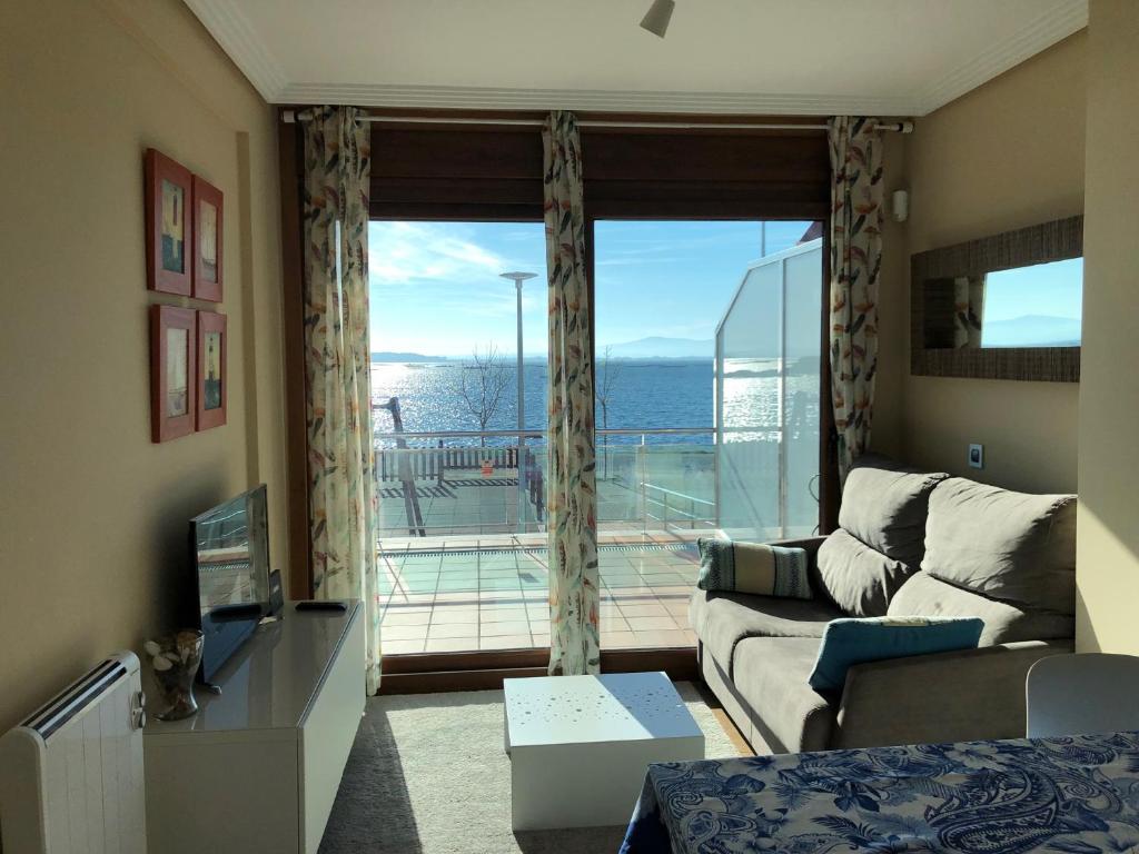 San PedroApartamento frente al mar的带沙发和大窗户的客厅