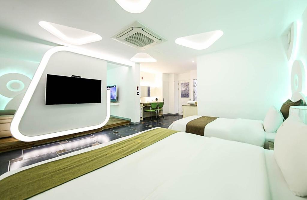 清州市Dubai Hotel的一间医院间 - 带两张床和电视