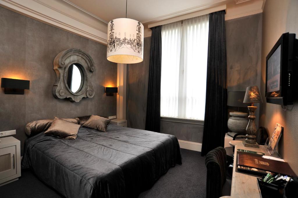 赫尔蒙德卢本消夫住宿加早餐旅馆的卧室配有一张床,墙上设有镜子