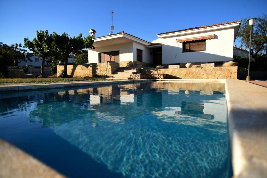 圣卡洛斯拉腊皮塔Casa Bel的房屋前的游泳池