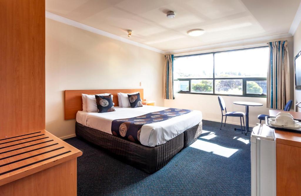 霍巴特黑水牛酒店的酒店客房配有一张床铺和一张桌子。