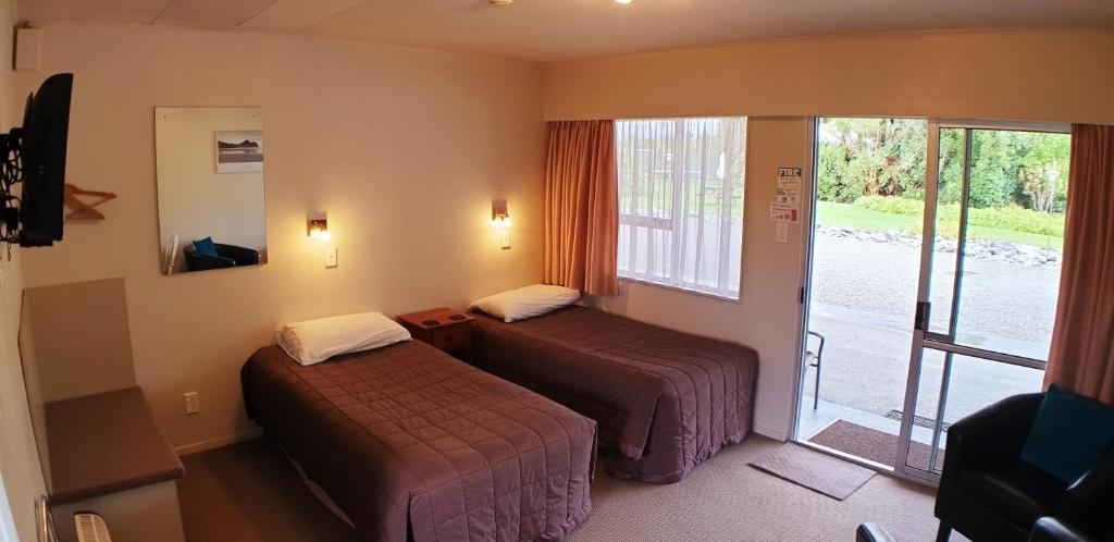 弗朗兹约瑟夫冰川景汽车旅馆 - 弗朗茨约瑟夫的酒店客房设有两张床和一个阳台。