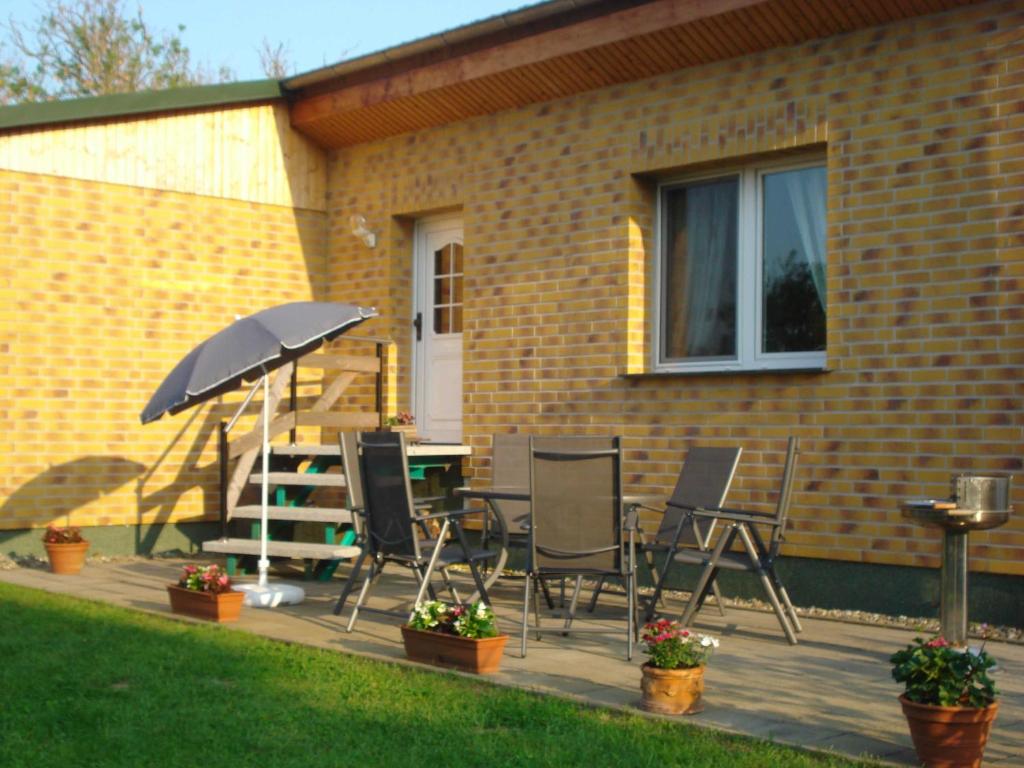 ZirkowRuegen_Fewo 37的庭院配有桌椅和遮阳伞。