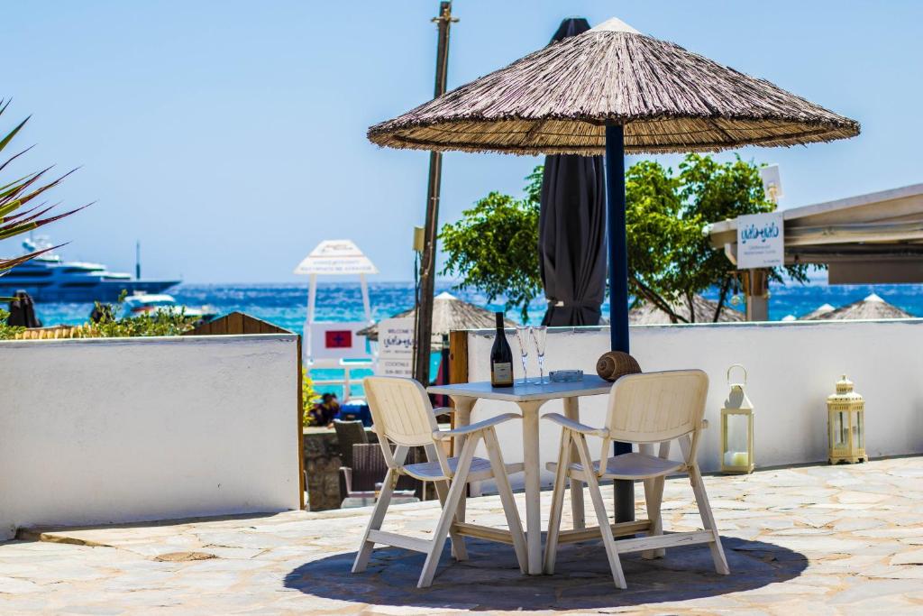 普拉迪斯亚罗斯浪漫酒店的一张桌子、两把椅子和一把伞
