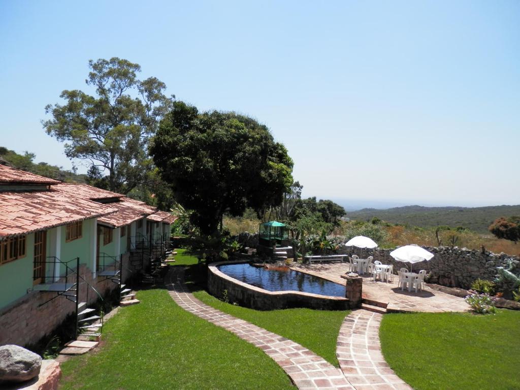 伊加图Pousada Pedras de Igatu的一个带游泳池和房子的庭院