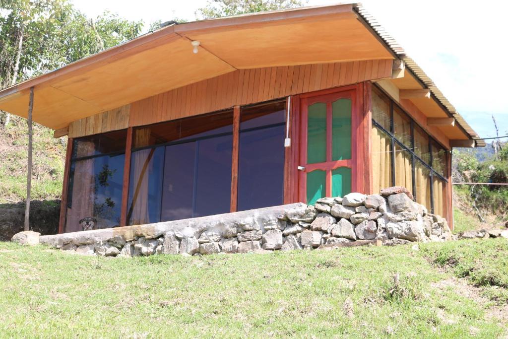 SalcantayLlactapata Lodge overlooking Machu Picchu - camping - restaurant的一座有红色门和石墙的房子