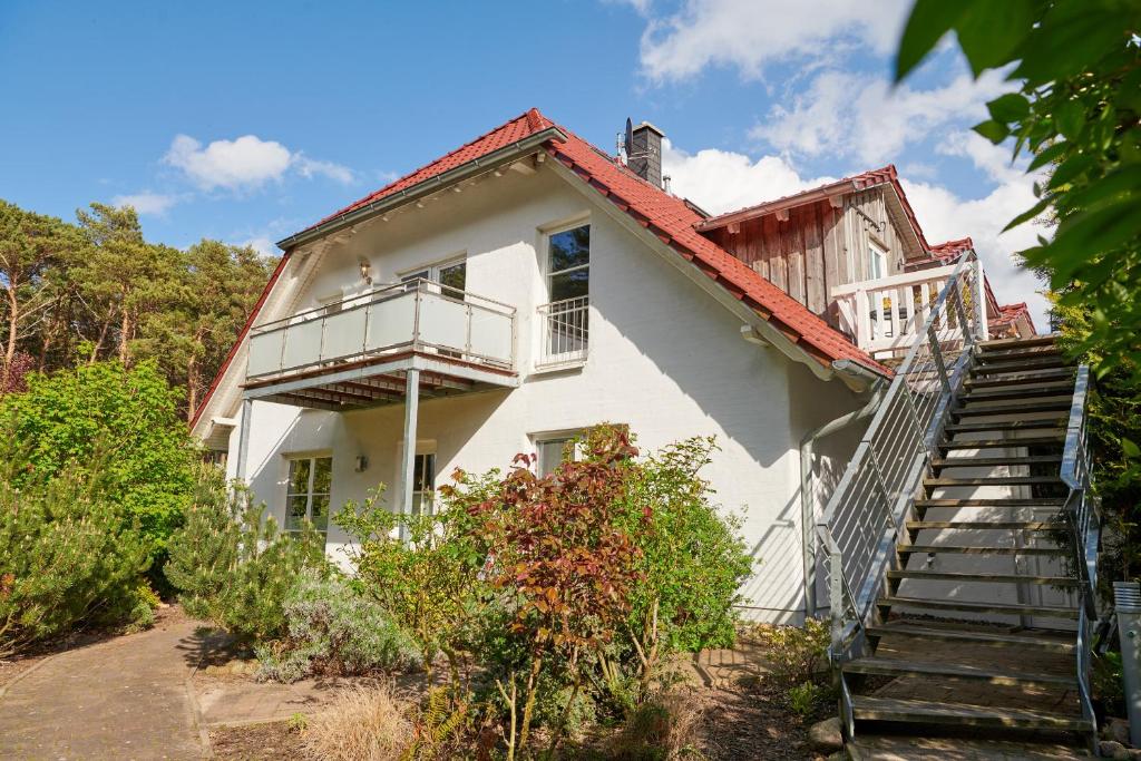 蒂索Sommerhaus Thiessow的白色的房子,有楼梯通往