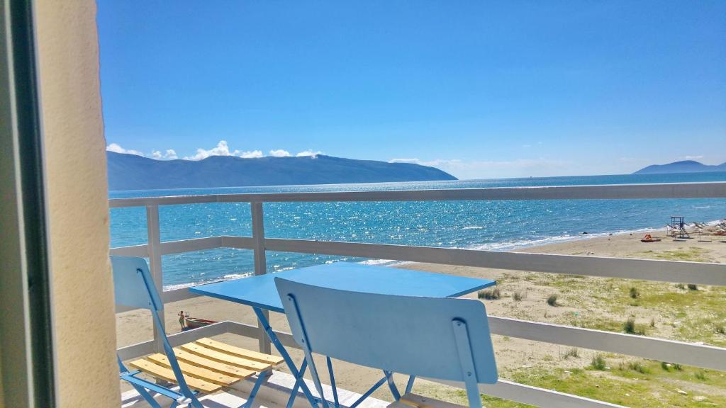 伏罗拉Adriatic Getaway的俯瞰海滩的阳台配有桌椅