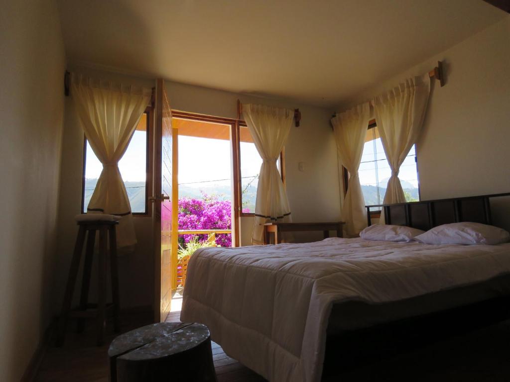 瓦拉斯Schatzi Lodge的一间卧室设有一张床和一个大窗户