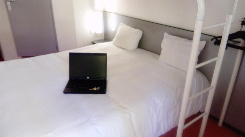 保拉扎克普瑞米尔佩里杰布拉扎克经典酒店的床上的笔记本电脑