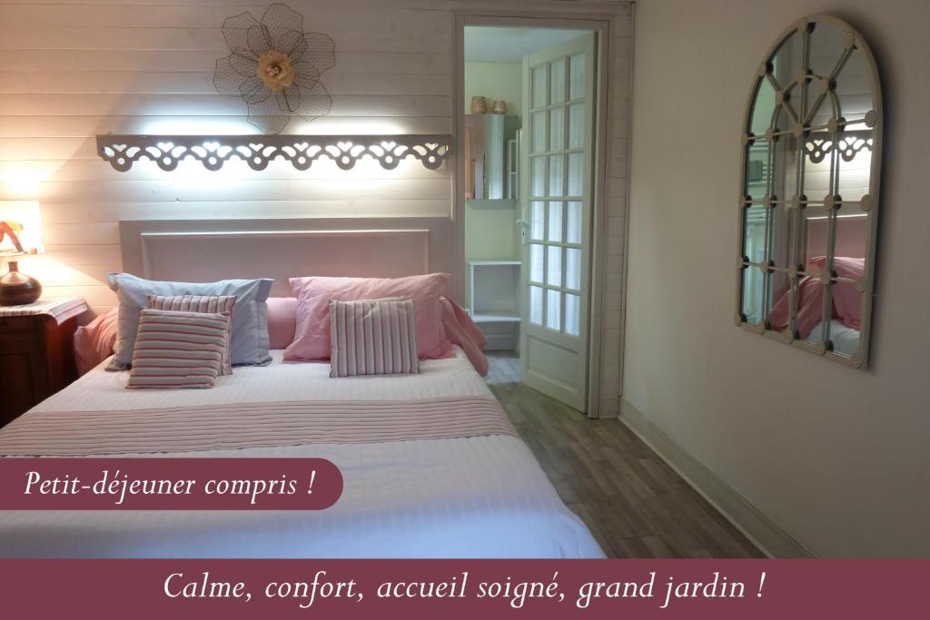 索克斯布鲁耶山住宿加早餐旅馆的一间卧室配有一张大床,配有粉色和蓝色的枕头