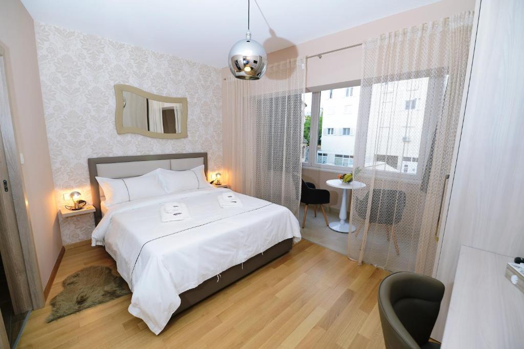 扎达尔Zoilo Rooms self check-in的卧室设有一张白色大床和一扇窗户。