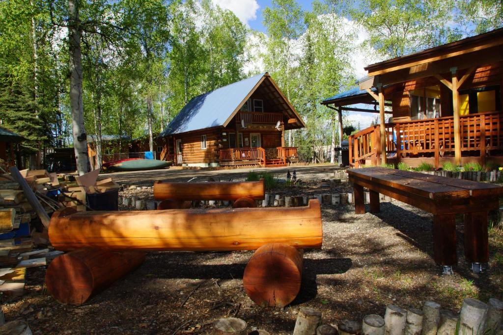 费尔班克斯Sven's Basecamp Hostel的小木屋设有桌子和木凳