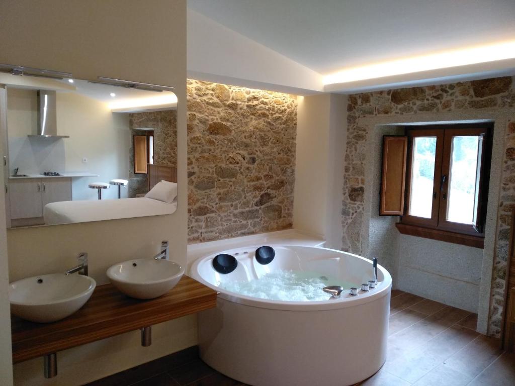 穆希亚VILAR DE LEMA的大型浴室设有两个盥洗盆和浴缸。