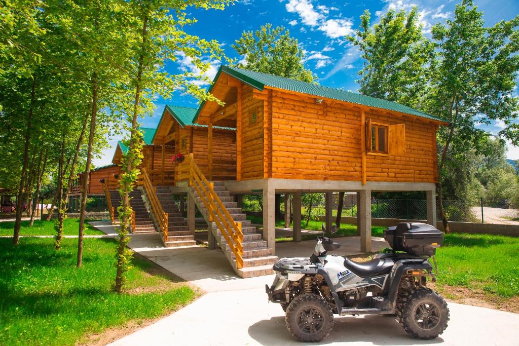 VranjinaEthno village Moraca - Skadar lake的停在小房子前面的摩托车