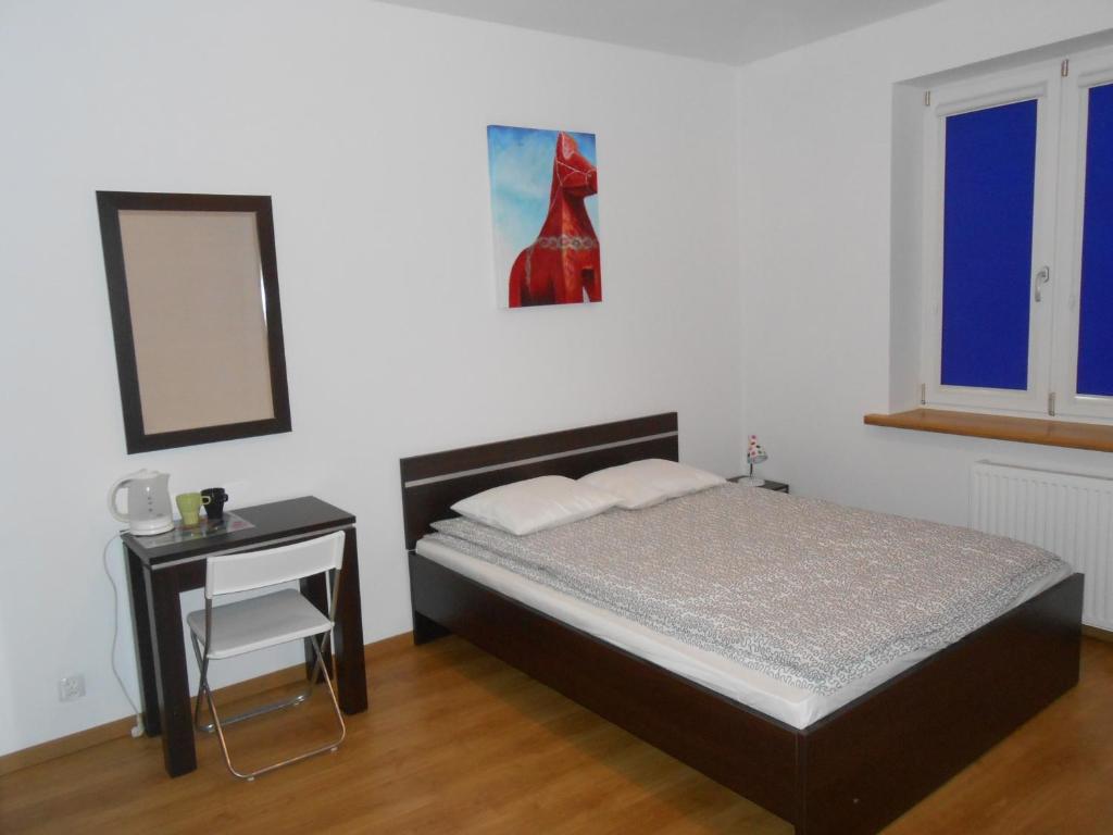 格丁尼亚Lux Hostel - z prywatnymi łazienkami的一间卧室配有一张床、一张桌子和一面镜子