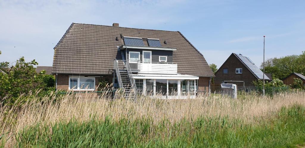 埃默尔斯比尔－霍斯比尔Ferienwohnungen Haus Schau ins Land nah an der Nordsee的一片高大的草场中的房屋