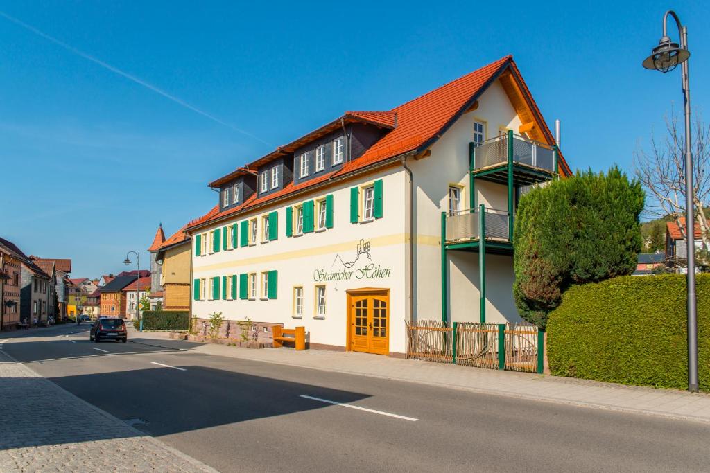 Kurort Steinbach-HallenbergStaimicher Höhen - Premium Appartements的一条街道上一座白色的大建筑,有红色的屋顶