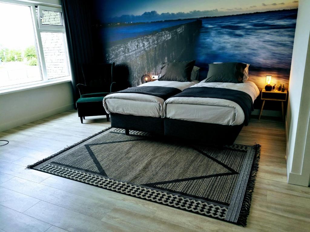 莱米尔Marina Strand Appartement Lemmer的卧室配有一张床,墙上挂有绘画作品