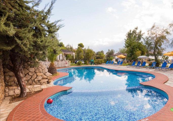 瓦西里亚斯vassilias beach hotel的蓝色海水度假村内的游泳池