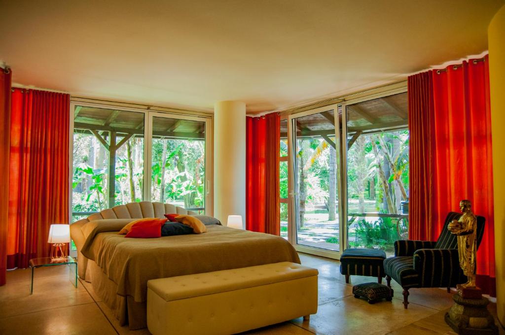 贾迪尼-纳克索斯B&B La Villa的卧室配有红色窗帘的床