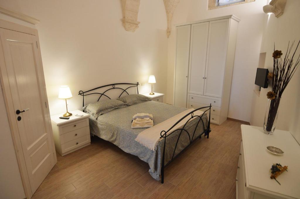 马丁纳弗兰卡La dimora di nonna Dora的一间卧室配有一张带2个床头柜和2盏灯的床。