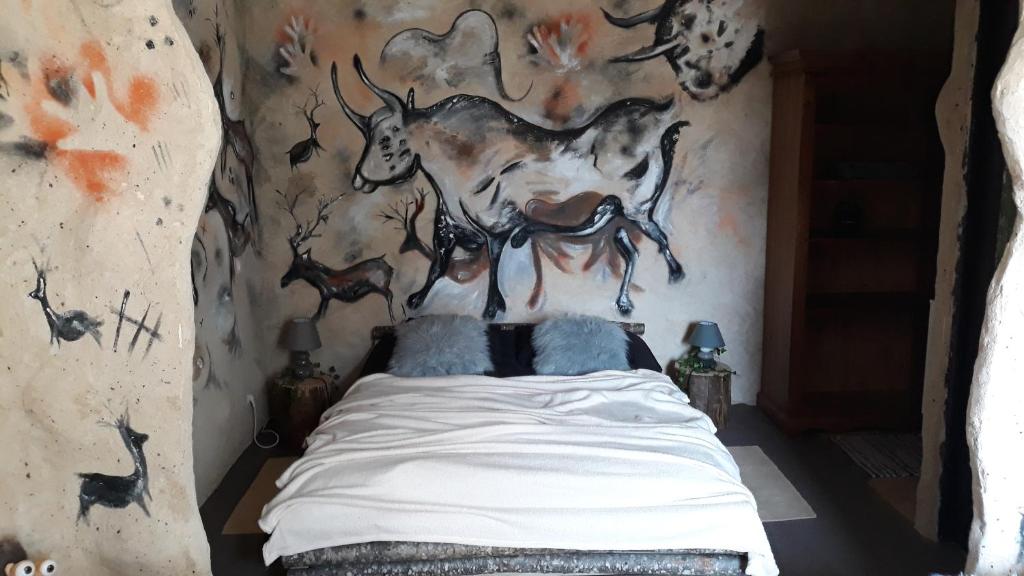Saint-Genièsprehistogite的一间卧室配有一张壁画床