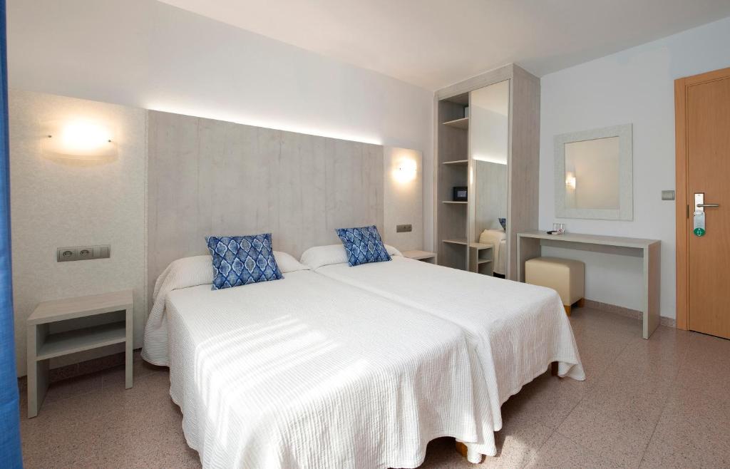 圣安东尼奥洛卡旅馆的卧室配有带蓝色枕头的大型白色床