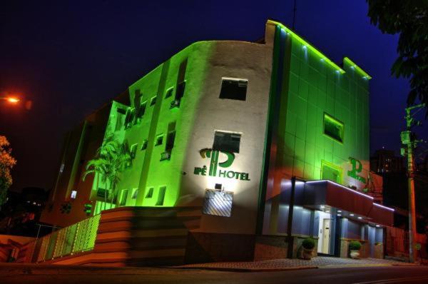 瓜鲁柳斯Ipê Guaru Hotel的一边有绿灯的建筑