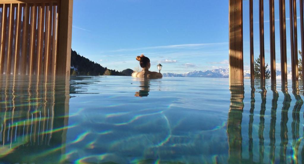 瓦雷纳Berghotel Jochgrimm - Your Dolomites Home的游泳池里水中的狗
