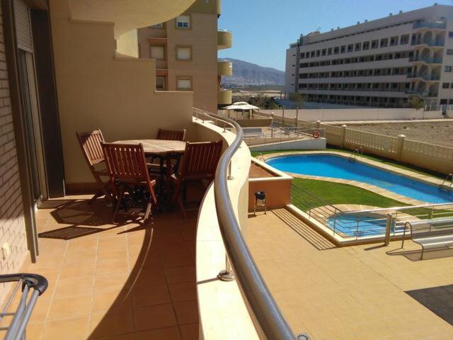 滨海罗克塔斯Las salinas Roquetas de Mar的一个带桌椅的阳台和一个游泳池