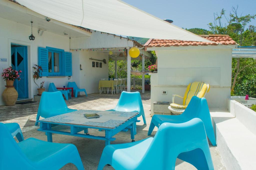 Sessa Cilento本温怒提内尔南基酒店的庭院配有蓝色的椅子和桌子