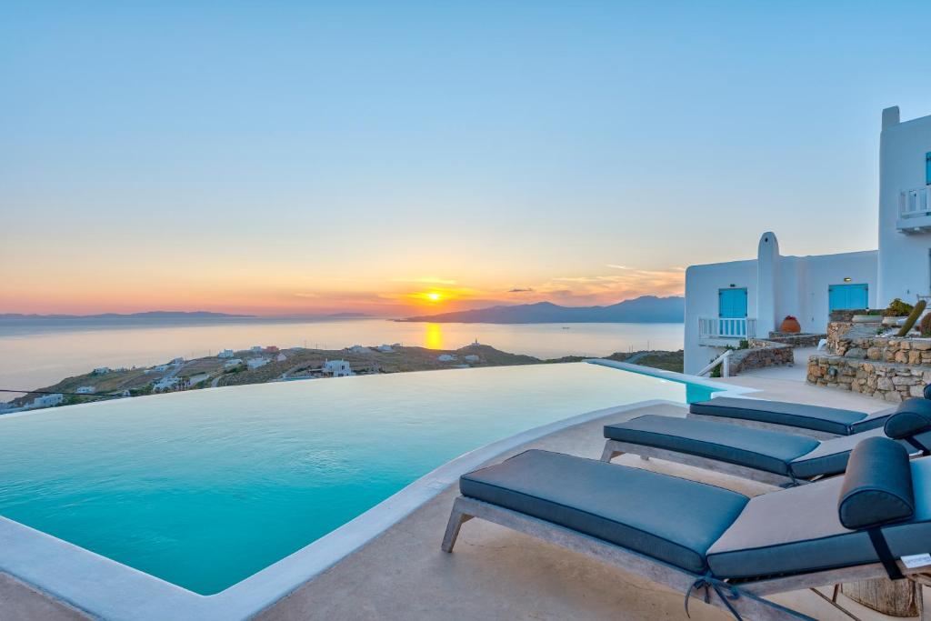 法纳里Mermaid Luxury Villas - Aquata Private pool的一个带椅子的游泳池,享有日落美景