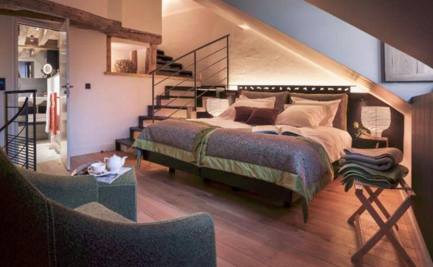 安锡阿纳西维埃耶威乐旅馆的一间卧室设有一张床和一个楼梯
