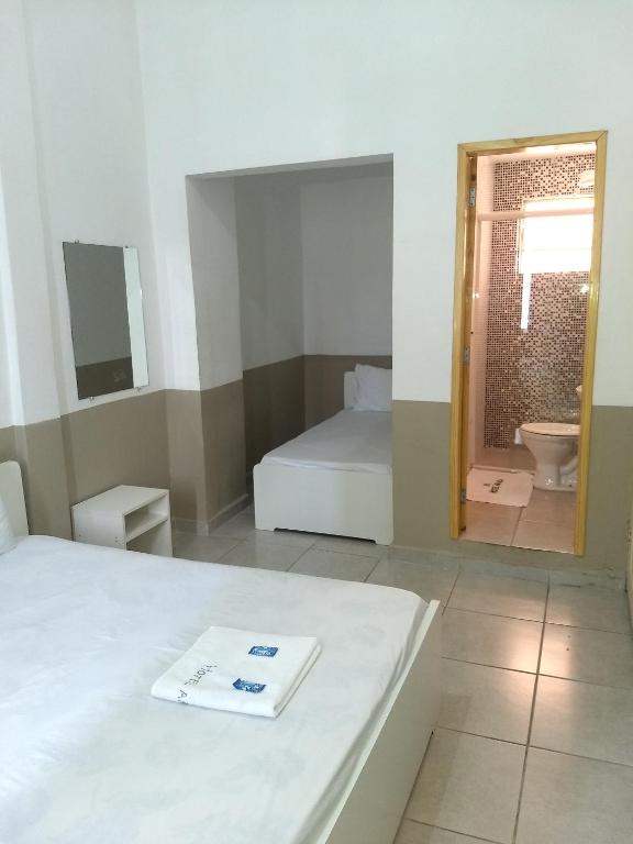 库里提巴Hotel Aruba的客房设有一张床和一间带镜子的浴室