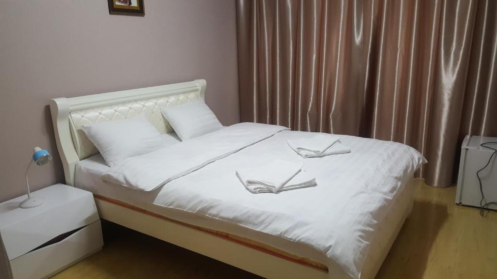 乌兰巴托Wonder Mongolia Guesthouse and Tour Operator LLC的卧室配有白色的床,上面有两只鸟