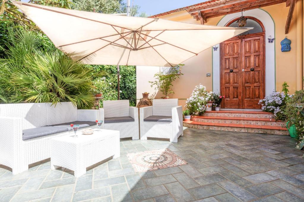 马萨鲁布朗斯阳光度假屋的庭院配有遮阳伞、椅子和桌子。