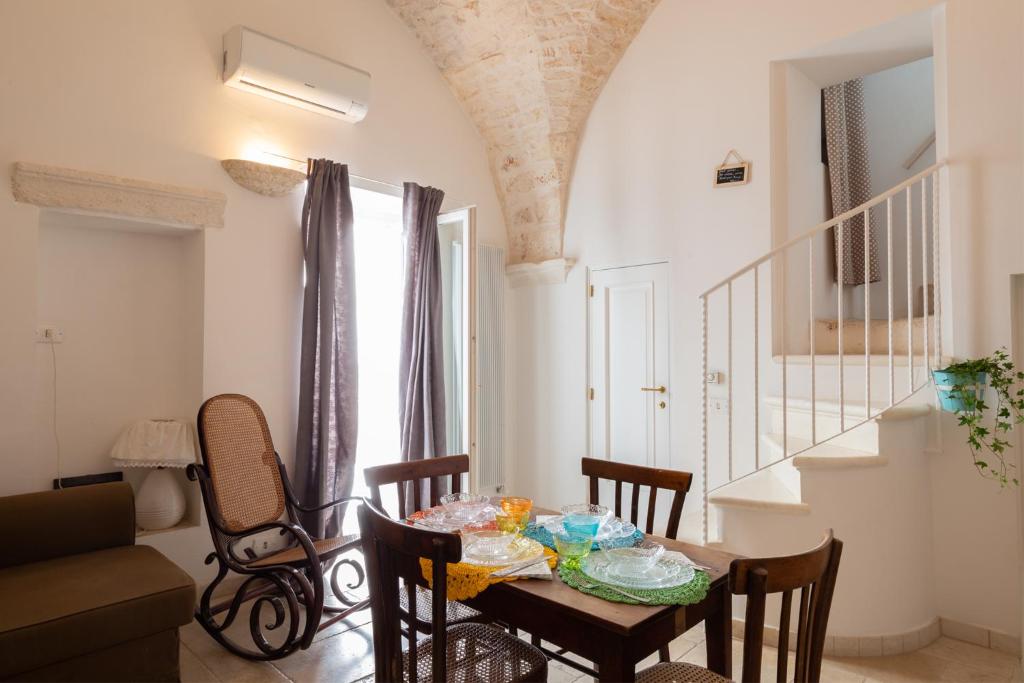 奥斯图尼安蒂卡彼得拉比安卡度假屋的一间带桌椅和楼梯的用餐室
